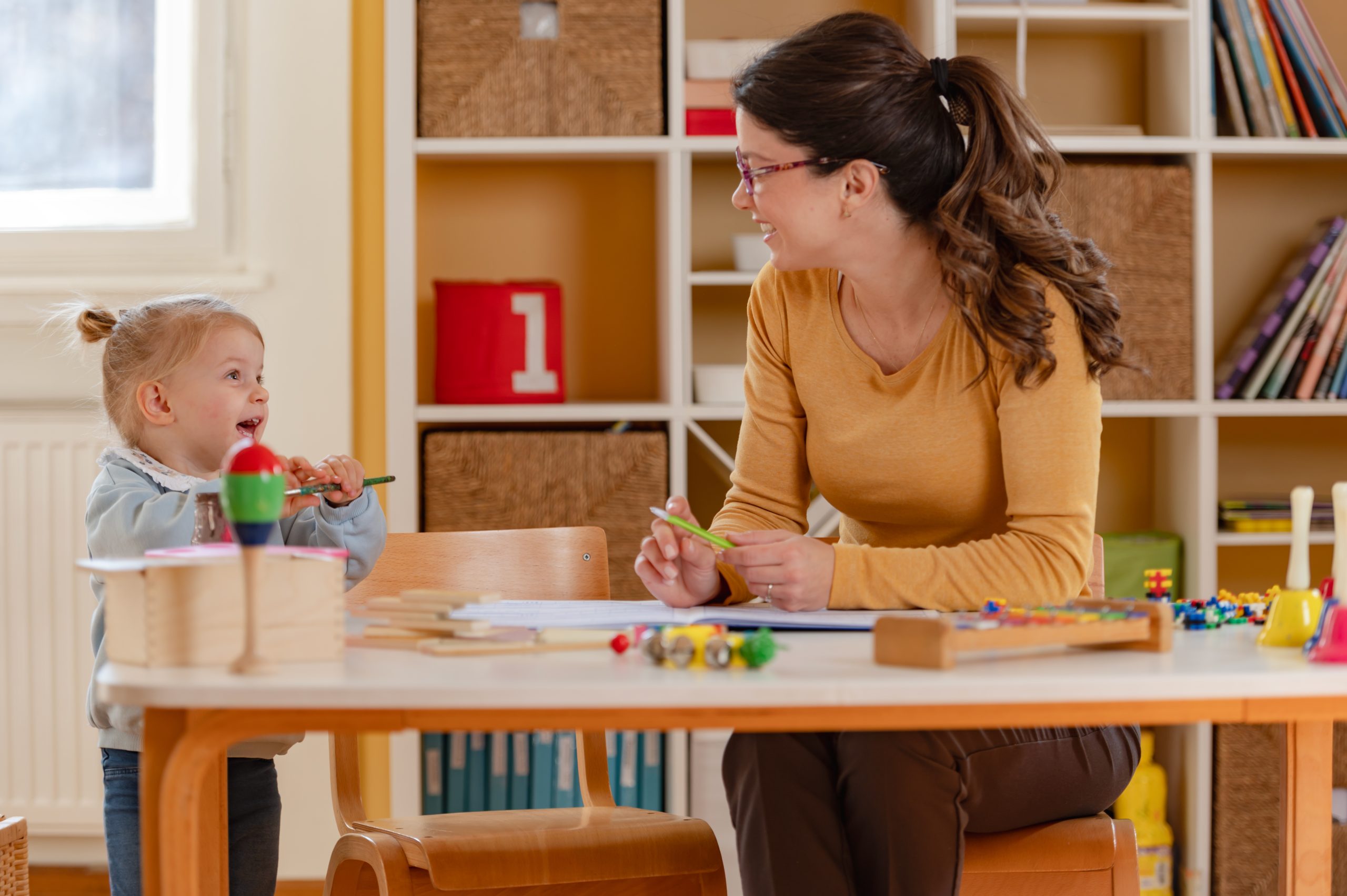 Preschool teacher interacting with toddler