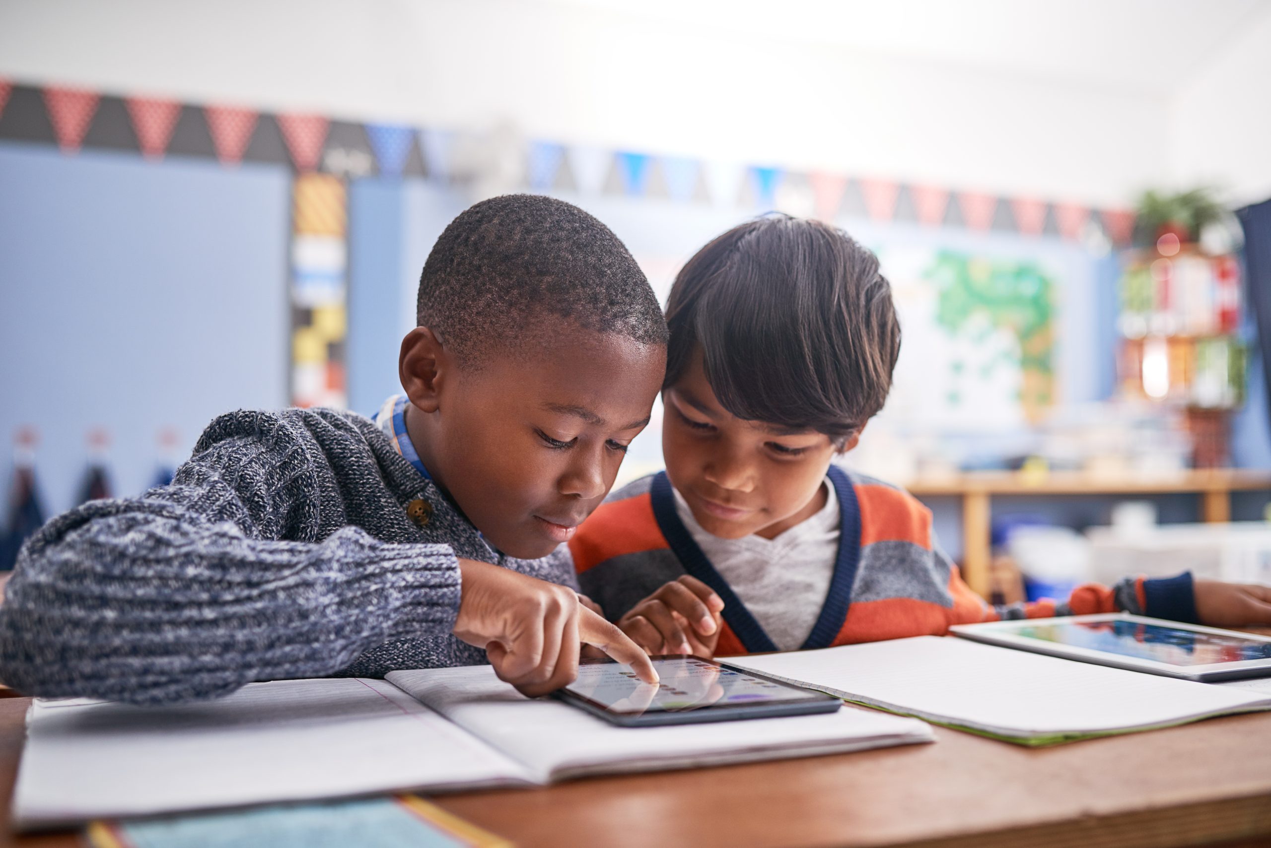 Students learning together on a tablet